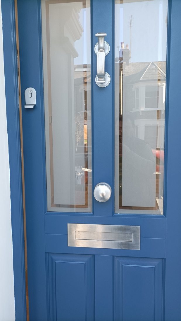 Painted blue front door with fittings